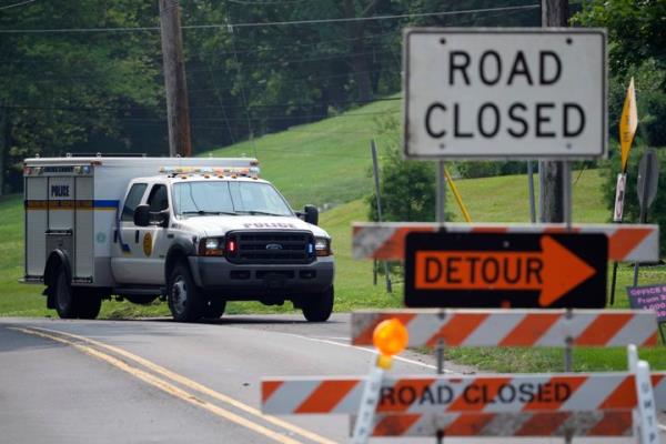 A roadblock is seen as crews search for a a pair of missing children swept away after weekend rains, Monday, July 17, 2023, in Washington Crossing, Pa. (AP Photo/Matt Slocum)