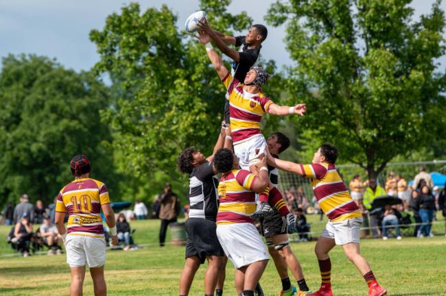 Elsie Allen player Joseva Keve, top, is hoisted by teammates as he goes for the ball in the team's Northern California victory this spring. (Brian Tucker)