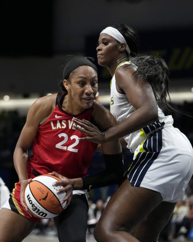 Las Vegas Aces forward A'ja Wilson (22) works for a shot as Dallas Wings' Kalani Brown, right, defends in the first half of a WNBA basketball game, Tuesday, Aug. 8, 2023, in Arlington, Texas. (AP Photo/Tony Gutierrez)