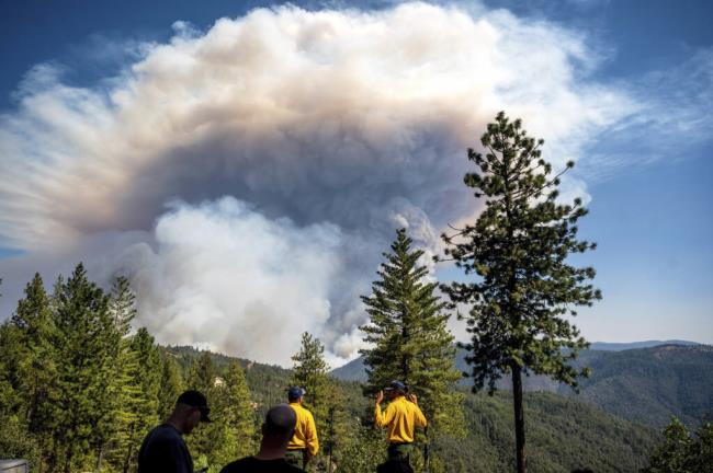 Firefighters in Placer County watch as a plume rises from the Mosquito Fire on Sept. 8, 2022. Photo by Noah Berger, AP Photo