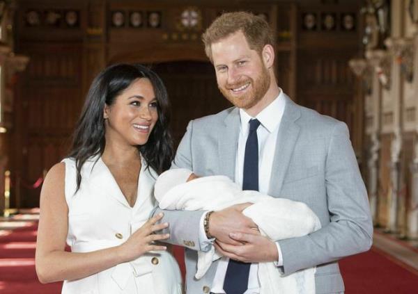 FILE - In this Wednesday May 8, 2019 file photo, Britain's Prince Harry and Meghan, Duchess of Sussex, during a photocall with their newborn son Archie, in St George's Hall at Windsor Castle, Windsor, south England. In a stunning declaration, Britain’s Prince Harry and his wife, Meghan, said they are planning