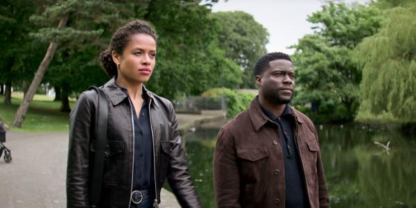 Gugu Mbatha-Raw and Kevin Hart walk in a park in Lift