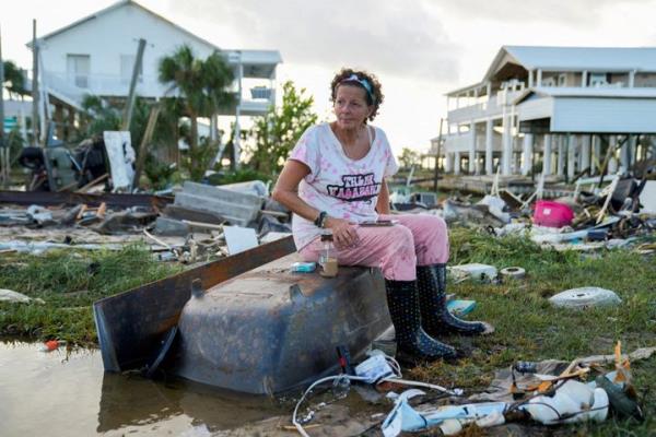Jewell Baggett, 51, sits on a bathtub amid the wreckage from Hurricane Idalia in Horseshoe Beach, Florida, on Wednesday.
